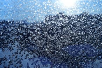 Beautiful ice pattern and sunlight on winter morning glass