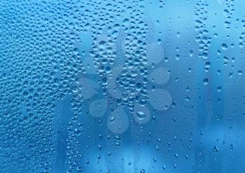 Blue texture with water drops on glass