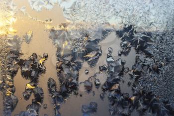 Beautiful natural ice pattern on winter window glass in the morning