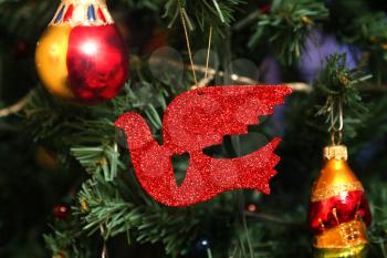 Beautiful decorations and red bird close up on faux Christmas tree