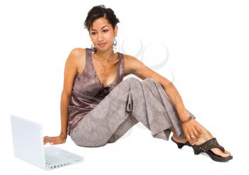 Mixed-race young woman using a laptop isolated over white