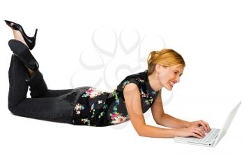 Royalty Free Photo of a Happy Lady Lying on the Floor Using her Laptop