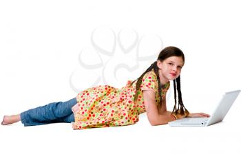 Royalty Free Photo of a Girl Laying on the Floor Using a Laptop
