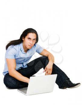 Royalty Free Photo of a Man Sitting on the Floor Using a Laptop