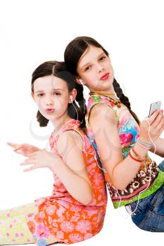 Royalty Free Photo of Two Young Girls Sitting on the Floor Listening to an Mp3 Player