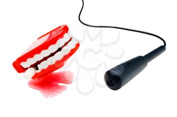 Dentures singing in microphone isolated over white