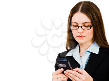 Businesswoman holding a mobile phone and text messaging isolated over white