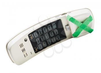 Adhesive tape on a cordless phone isolated over white