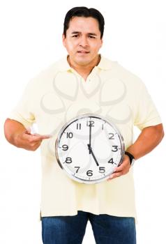 Mid adult man pointing at a clock isolated over white