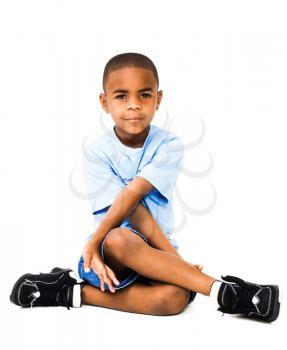 Happy boy sitting and posing isolated over white