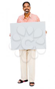 Smiling mature man showing a placard isolated over white