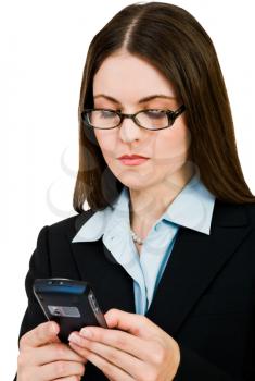 Gorgeous businesswoman text messaging on a mobile phone isolated over white