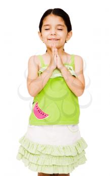 Happy girl standing in prayer position isolated over white