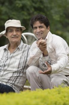 Portrait of a man with his father in a park