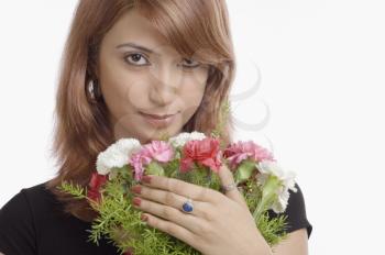 Portrait of a woman holding bouquet of Carnation flowers