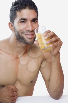 Portrait of a macho man drinking juice