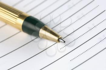 Close-up of a ballpoint pen with a paper