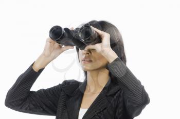 Businesswoman looking through binoculars