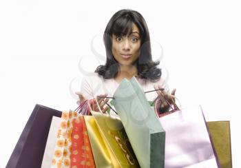 Surprised young woman carrying shopping bags