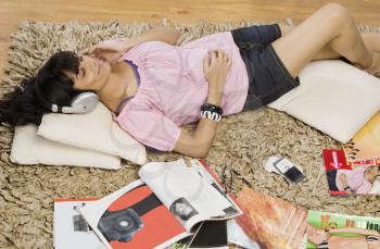 Young woman listening music in a living room