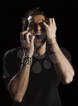Close-up of a man scratching his face