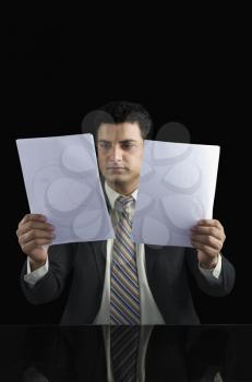 Businessman holding two documents