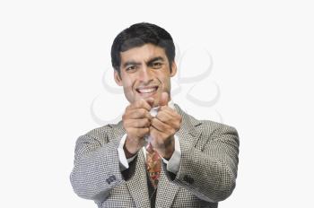 Businessman tearing a sheet of paper in frustration