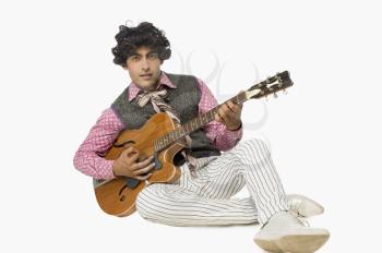 Portrait of a businessman playing a guitar