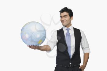 Businessman holding a globe and smiling