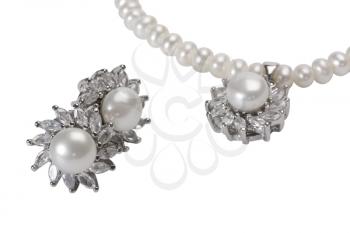 Close-up of pearl earrings with a pearl necklace