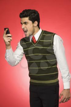 Businessman shouting on a mobile phone
