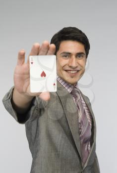 Businessman showing ace of hearts card