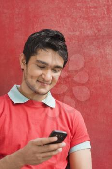 Man text messaging on a mobile phone