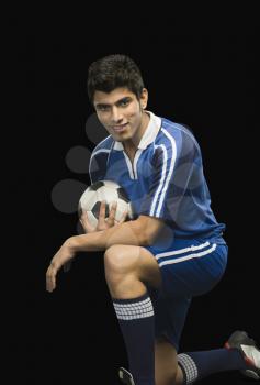 Portrait of a soccer player with a soccer ball