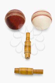 Cricket balls and bails forming an anthropomorphic face