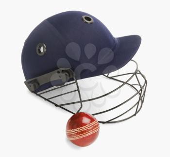 Close-up of a cricket ball and a helmet