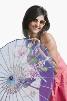 Woman holding a parasol and smiling