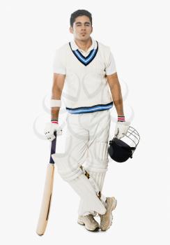 Cricket batsman holding a bat and helmet