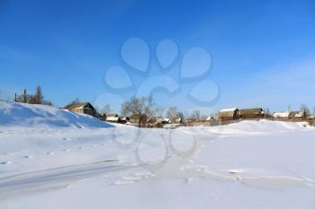 village on coast winter river