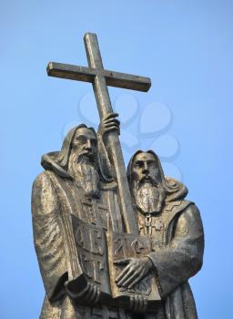 Monks with cross on the blue background
