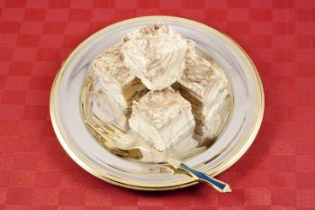 Delicious Halva served in silver-golden dish on red table