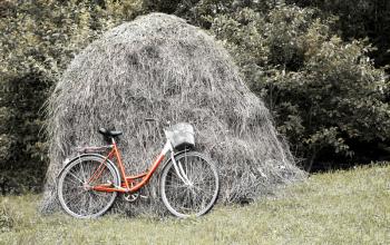 Royalty Free Photo of a Bike Against a Haystack