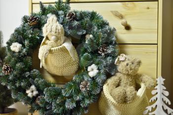 Christmas wreath and soft children's toys in knitted bags