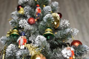 Decoration in the form of bells, balls and nutcrackers hanging on a Christmas tree