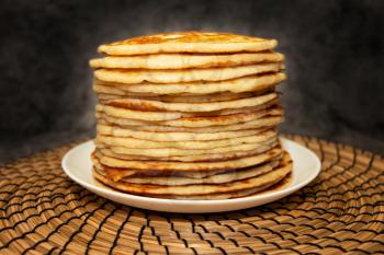 Stack of fresh and flavorful pancakes on dark background