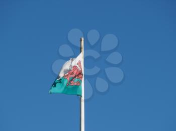 the Welsh national flag of Wales, UK over blue sky
