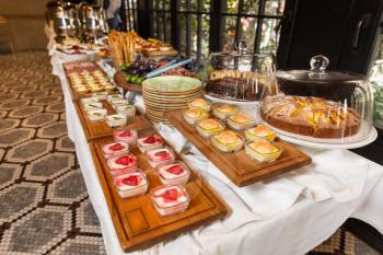 Tasty desserts on the wooden plate