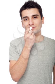 Royalty Free Photo of a Man Applying Lip Balm