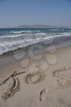 Royalty Free Photo of Kos Written on a Beach in Kos, Greece