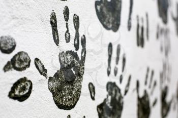 Black hand-prints on a wall